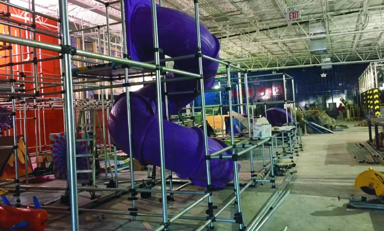 Tube slide and steel playground frames during on-site installation