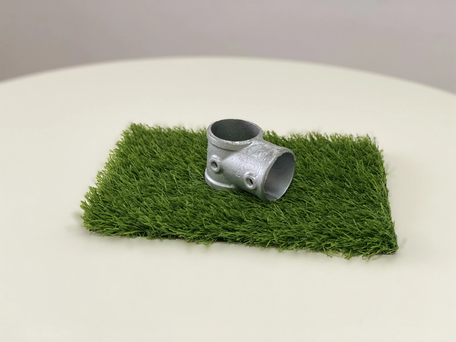 Metal frame connector fitting for a modular playground structure