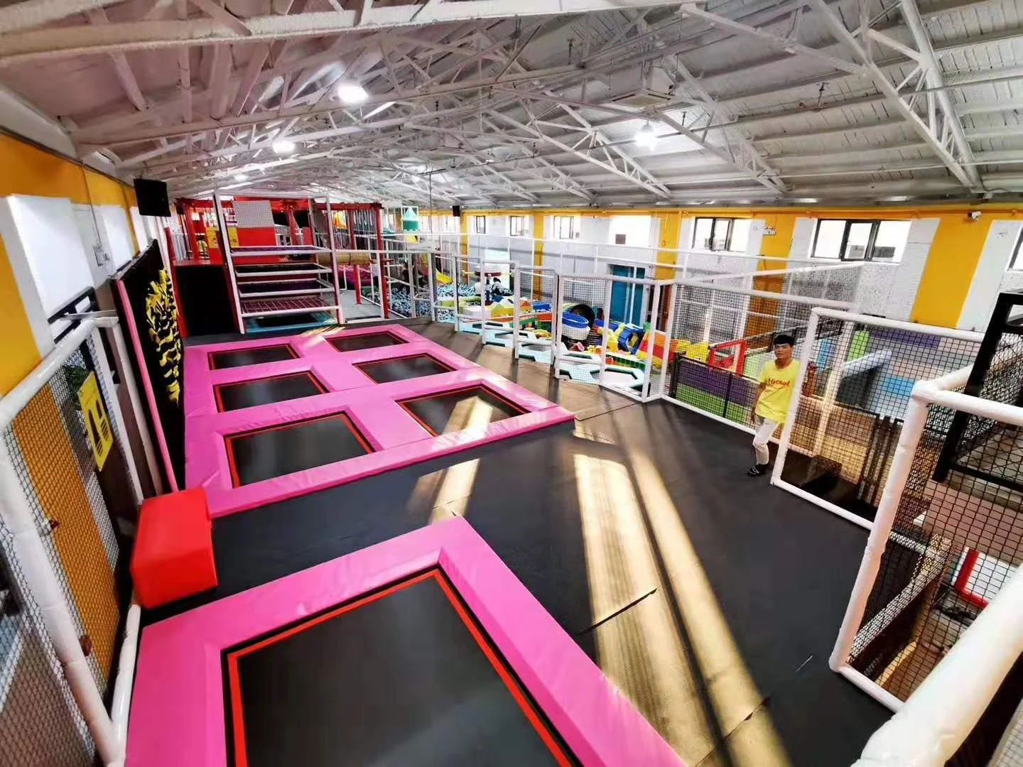 Completed play venue showing well-maintained post padding and trampoline courts